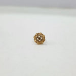 Front view of small floral gold nose pin on a white background displaying precise design and finish