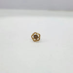Front view of a small floral gold nose pin on a white background showing fine detailing