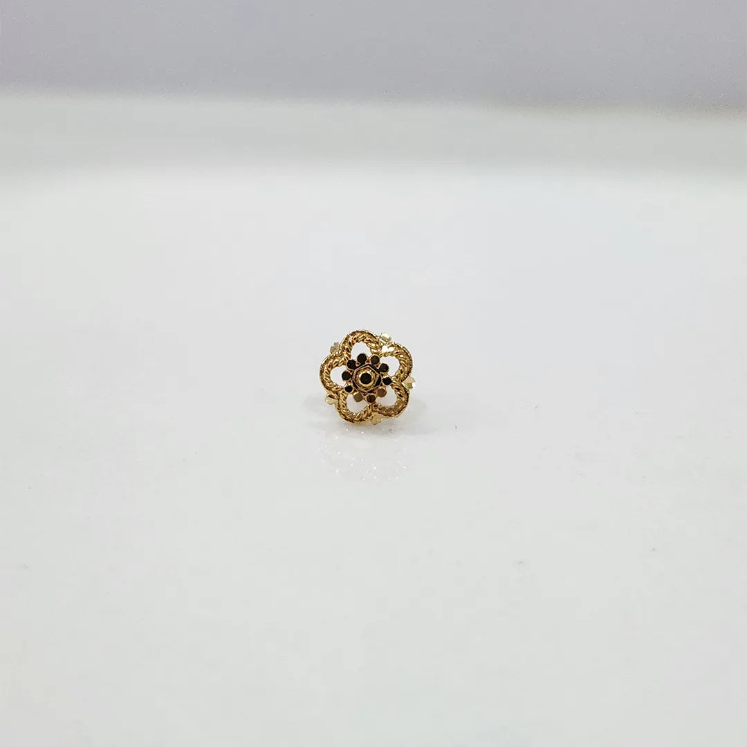 Front view of a small floral gold nose pin on a white background showing fine detailing