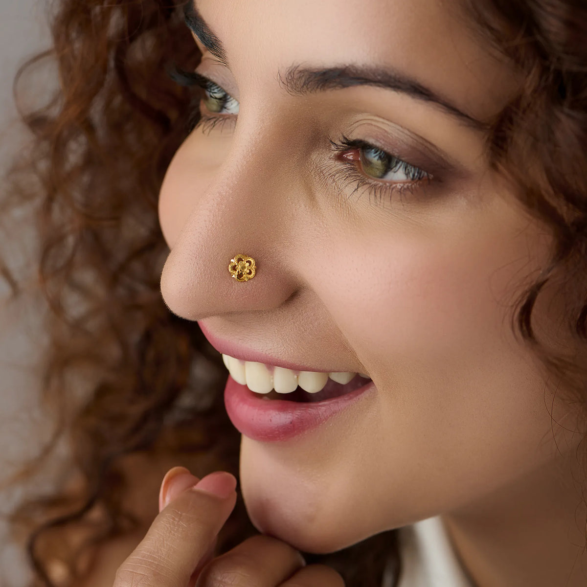 Woman wearing a floral gold nose pin showcasing an elegant everyday traditional look