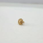 Side angle of the floral gold nose pin on a white background highlighting its compact size and smooth polish