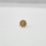 Front view of a small floral gold nose pin on a white surface showing precise design and fine finish