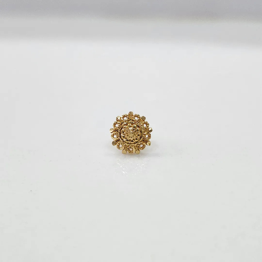 Front view of a small floral gold nose pin on a white surface showing precise design and fine finish