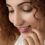 Woman wearing floral 18K nose pin gold showcasing a delicate and elegant ethnic look