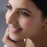 Woman wearing a delicate gold nose pin smiling gently showcasing an elegant everyday look