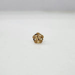 Side angled view of the floral 18K gold nose pin on a white background showing depth and craftsmanship