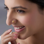 Front profile of a woman wearing a floral 18K gold nose pin showcasing elegant everyday styling