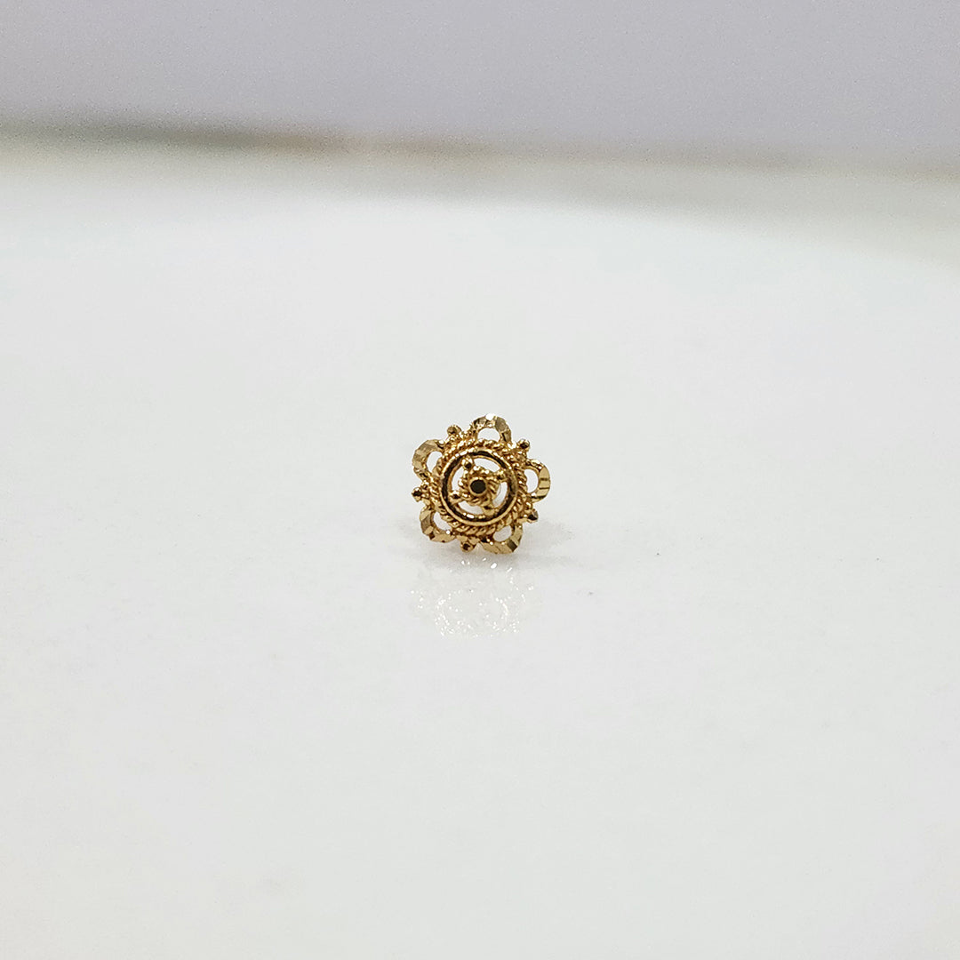 Close up of handcrafted floral gold nose pin design on white background elegant and minimal style