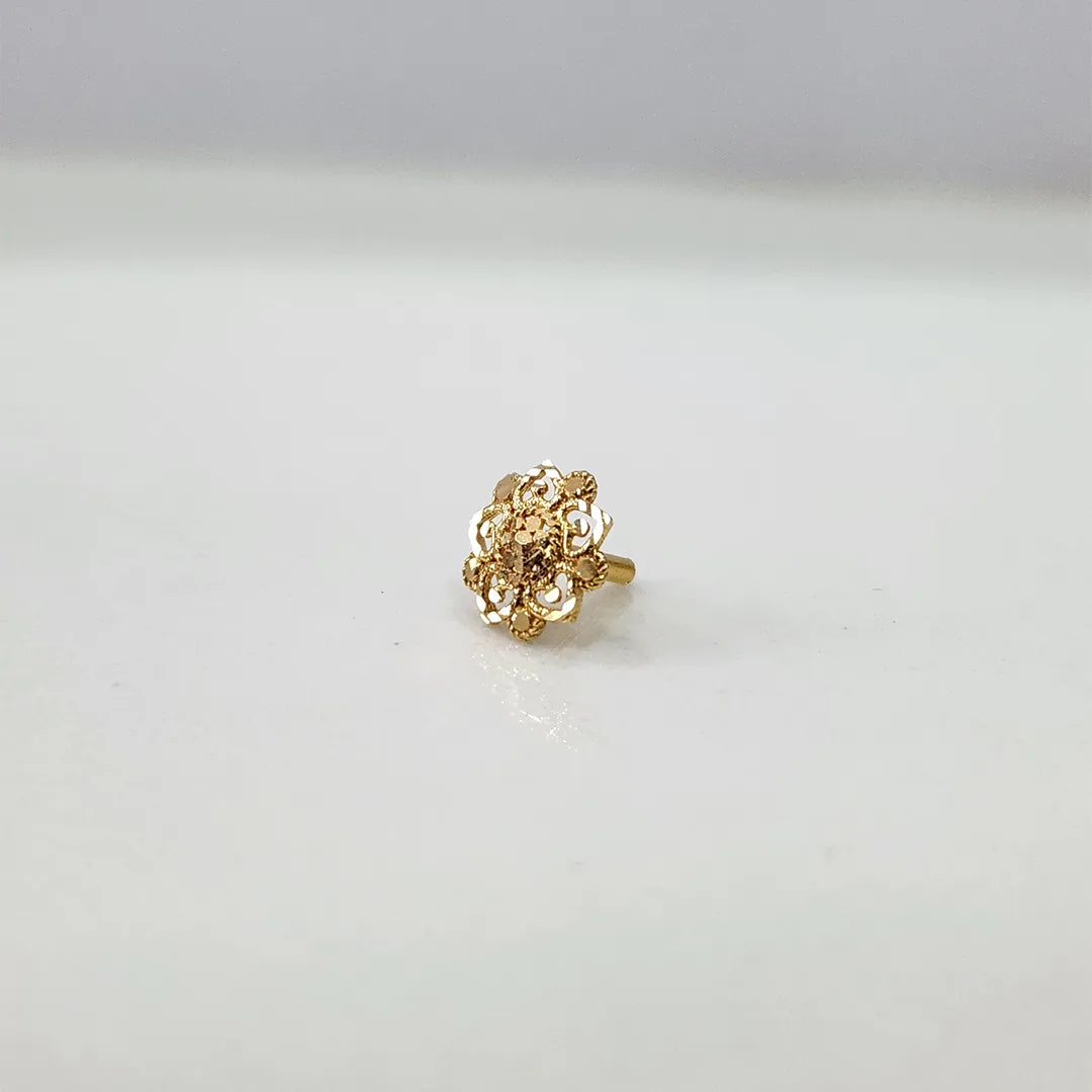 Small floral 18K nose pin gold placed on a white background showing fine handcrafted detailing