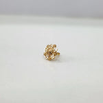 Small floral 18K nose pin gold placed on a white background showing fine handcrafted detailing