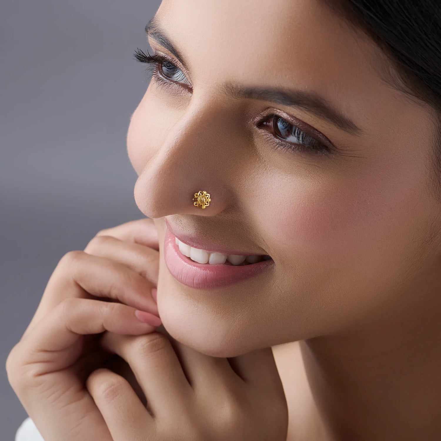 Woman wearing floral 18K nose pin gold showcasing an elegant and natural everyday look