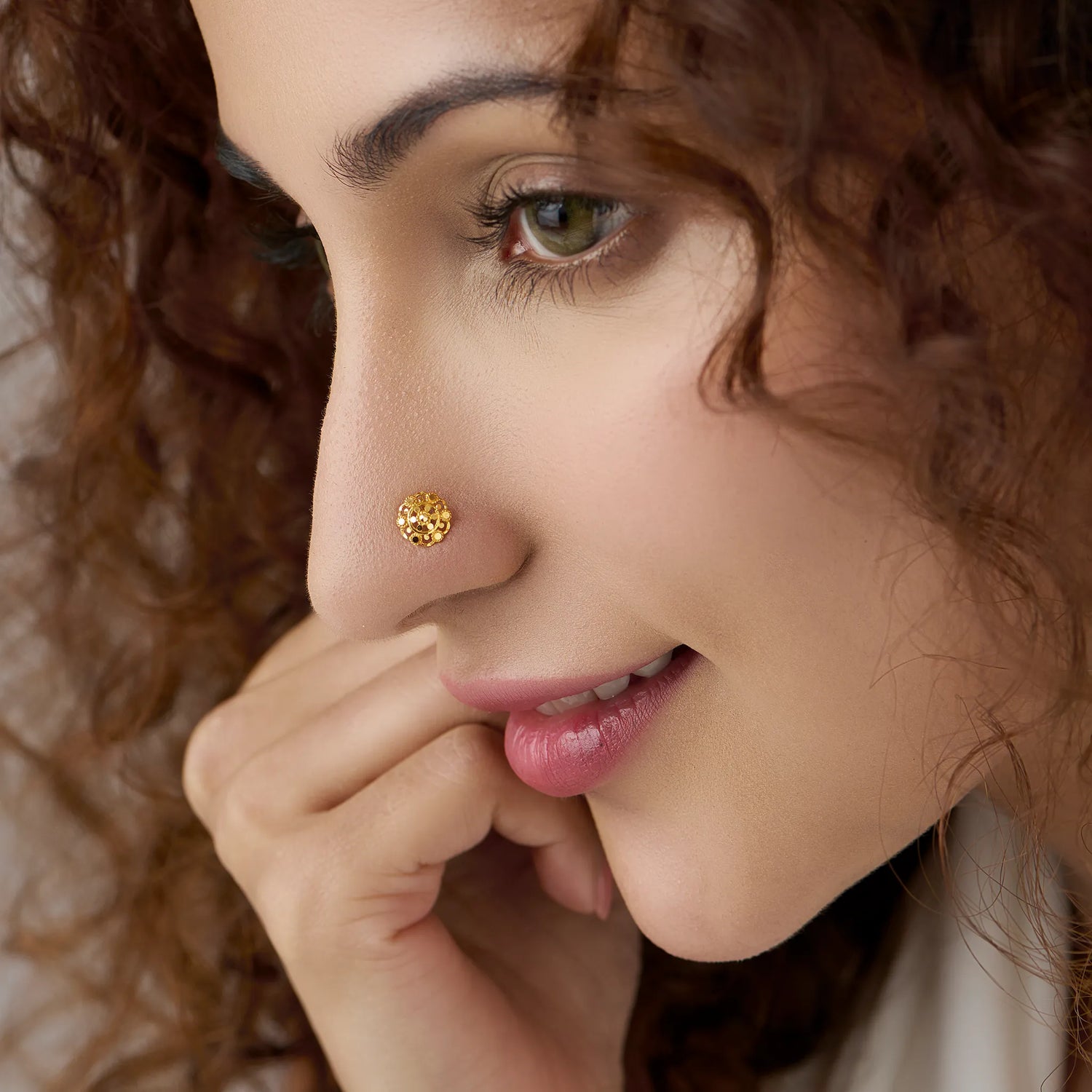 Woman wearing a floral gold nose pin showing an elegant and graceful everyday look