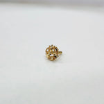 Front view of a floral gold nose pin placed on a white background showing compact size and design clarity