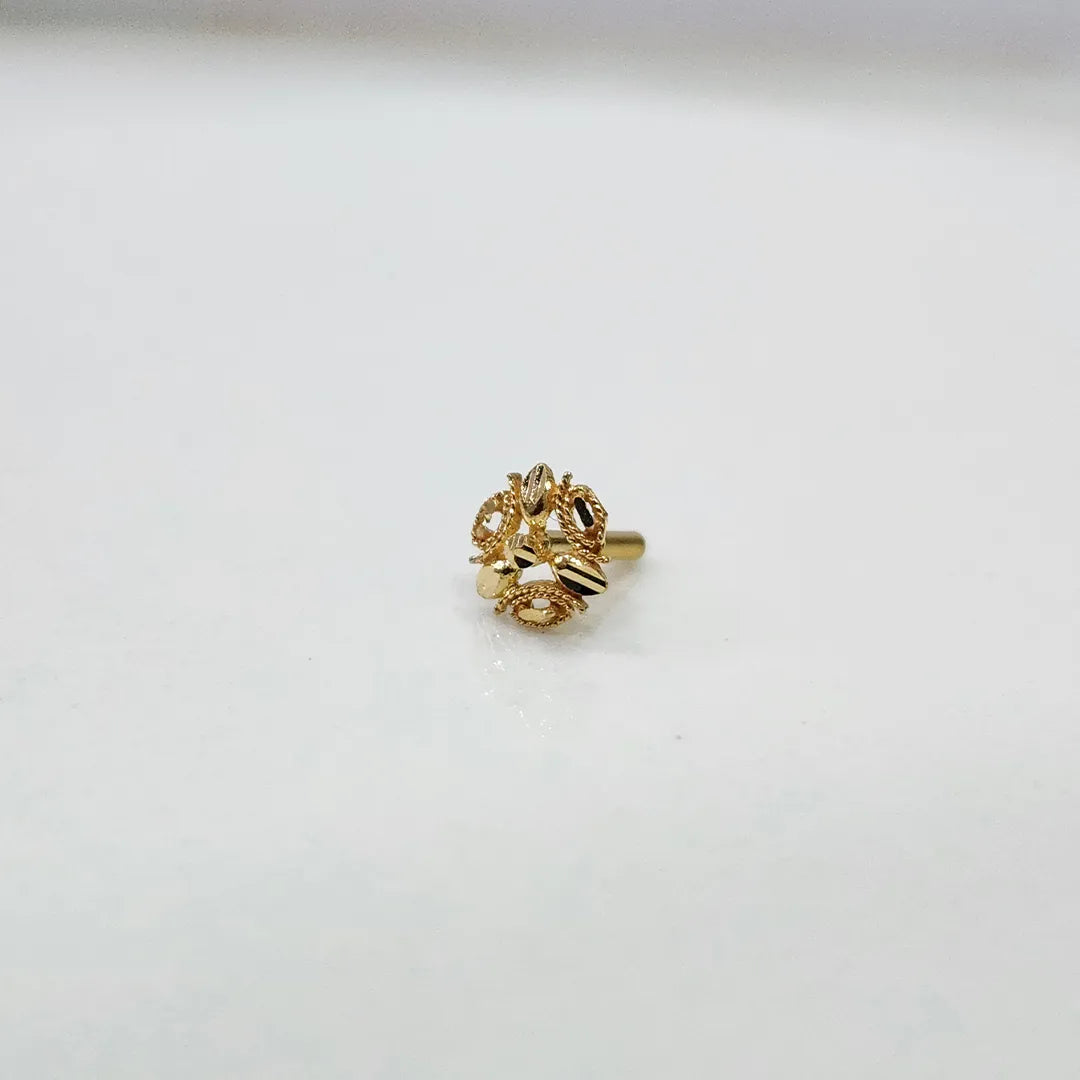 Front view of a floral gold nose pin placed on a white background showing compact size and design clarity
