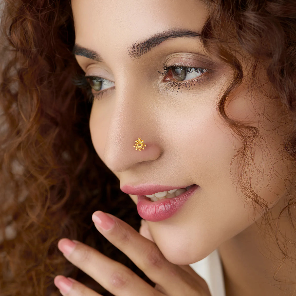 Woman wearing floral 18K nose pin gold showcasing a delicate and elegant everyday ethnic look