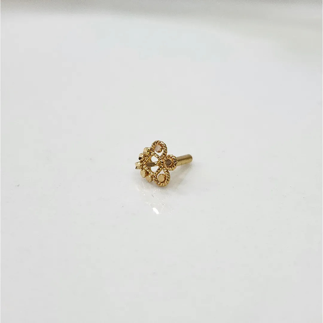 Small floral 18K nose pin gold placed on a white background showing fine detailing