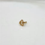 Small floral 18K nose pin gold placed on a white background showing fine detailing