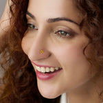 Woman wearing floral 18K nose pin gold showcasing an elegant and natural everyday look
