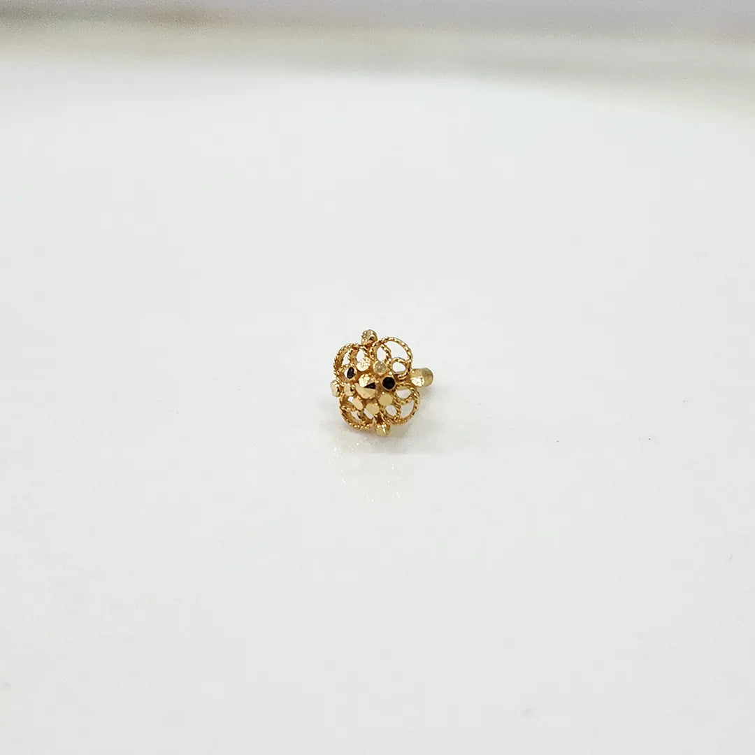 Front view of small floral 18K gold nose pin on a white background showing compact size and fine detailing