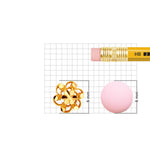 18K gold nose pin placed beside pencil eraser for clear size comparison on measurement grid