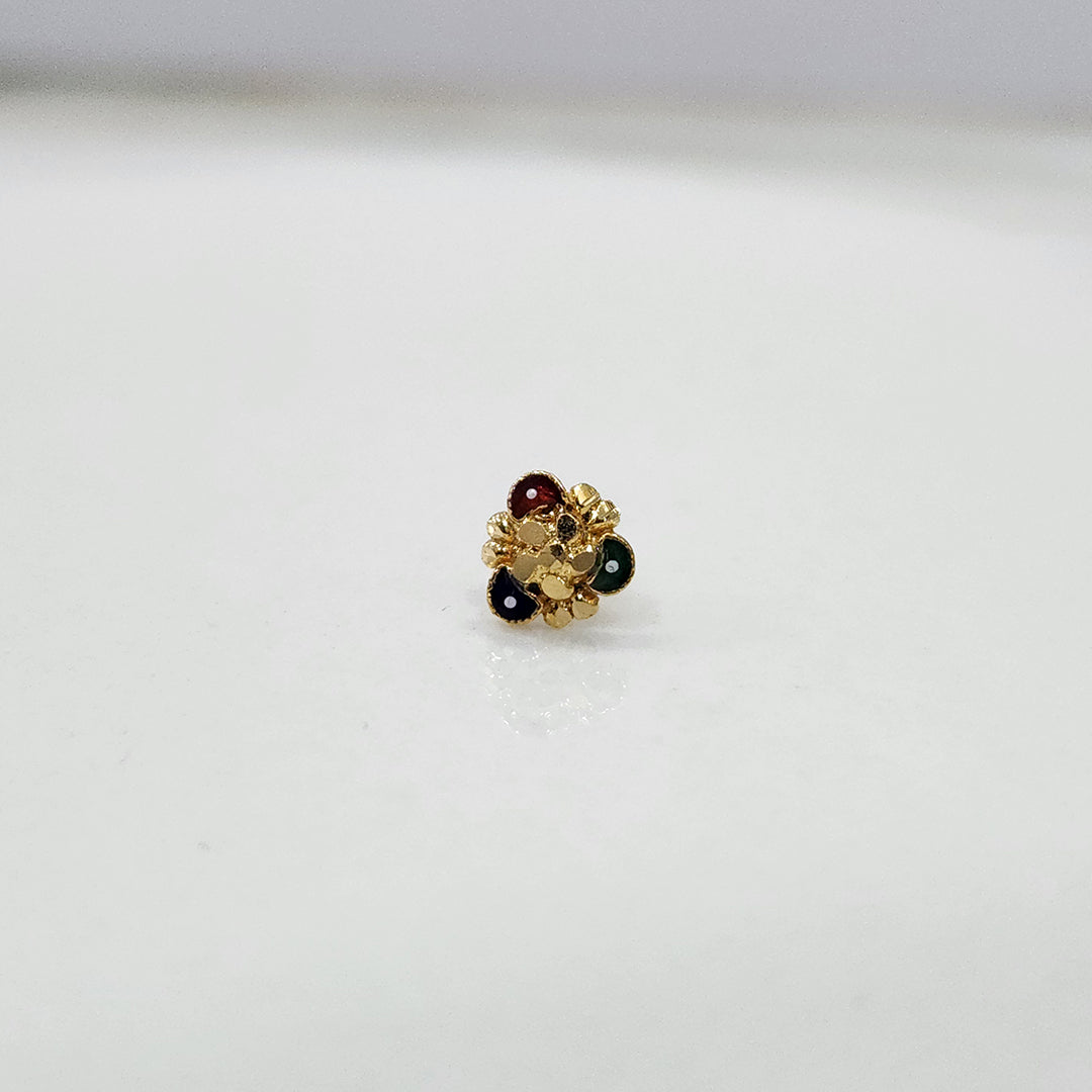 Slight angled view of the floral gold nose pin highlighting its design and stone placement