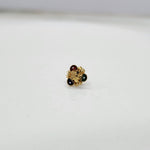 Slight angled view of the floral gold nose pin highlighting its design and stone placement