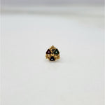 Slight angled view of the floral gold nose pin highlighting the stone arrangement and craftsmanship