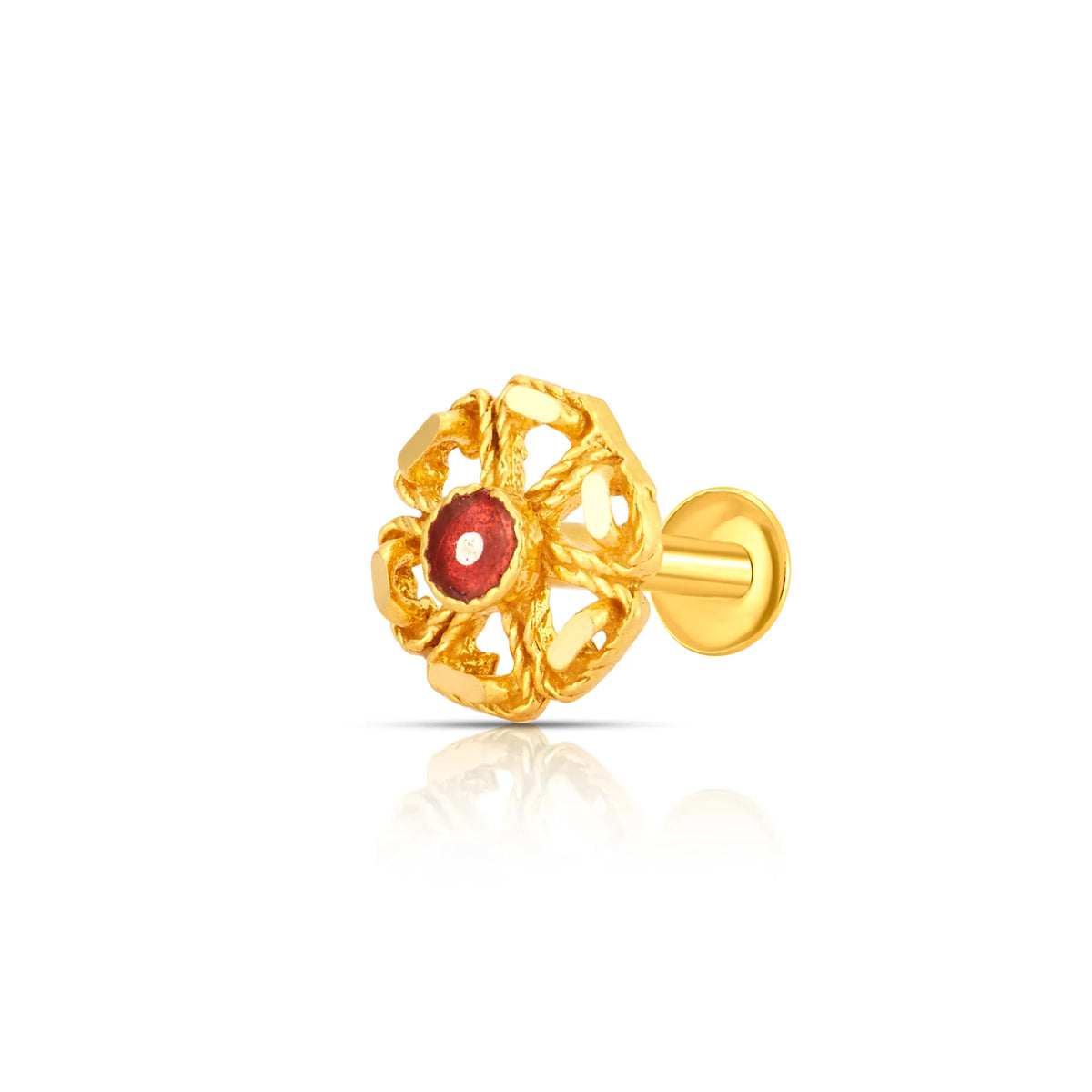Close-up of intricate floral 18K nose pin gold with a red stone centerpiece placed on a white reflective background showing fine detailing