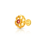 Close-up of intricate floral 18K nose pin gold with a red stone centerpiece placed on a white reflective background showing fine detailing