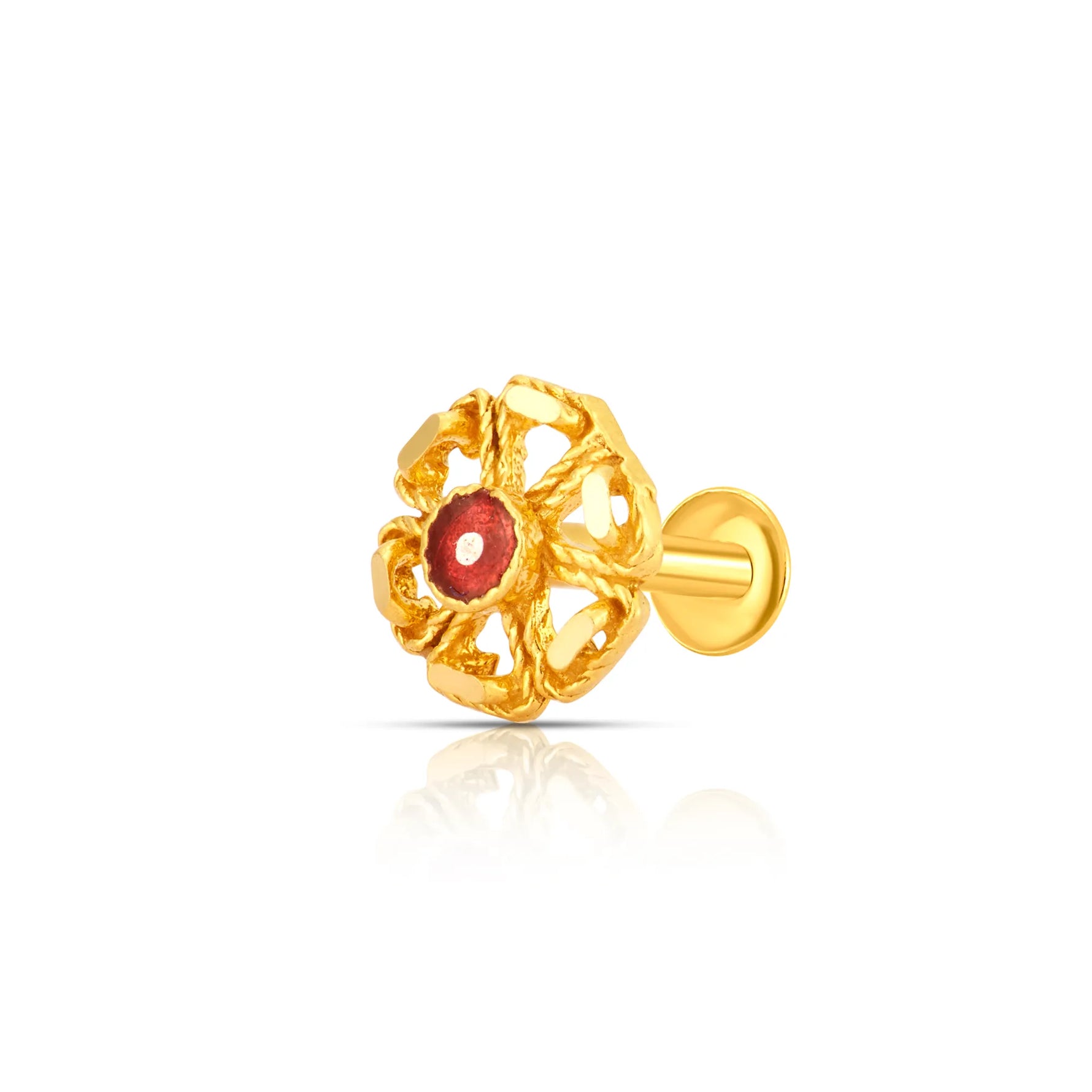 Close-up of intricate floral 18K nose pin gold with a red stone centerpiece placed on a white reflective background showing fine detailing