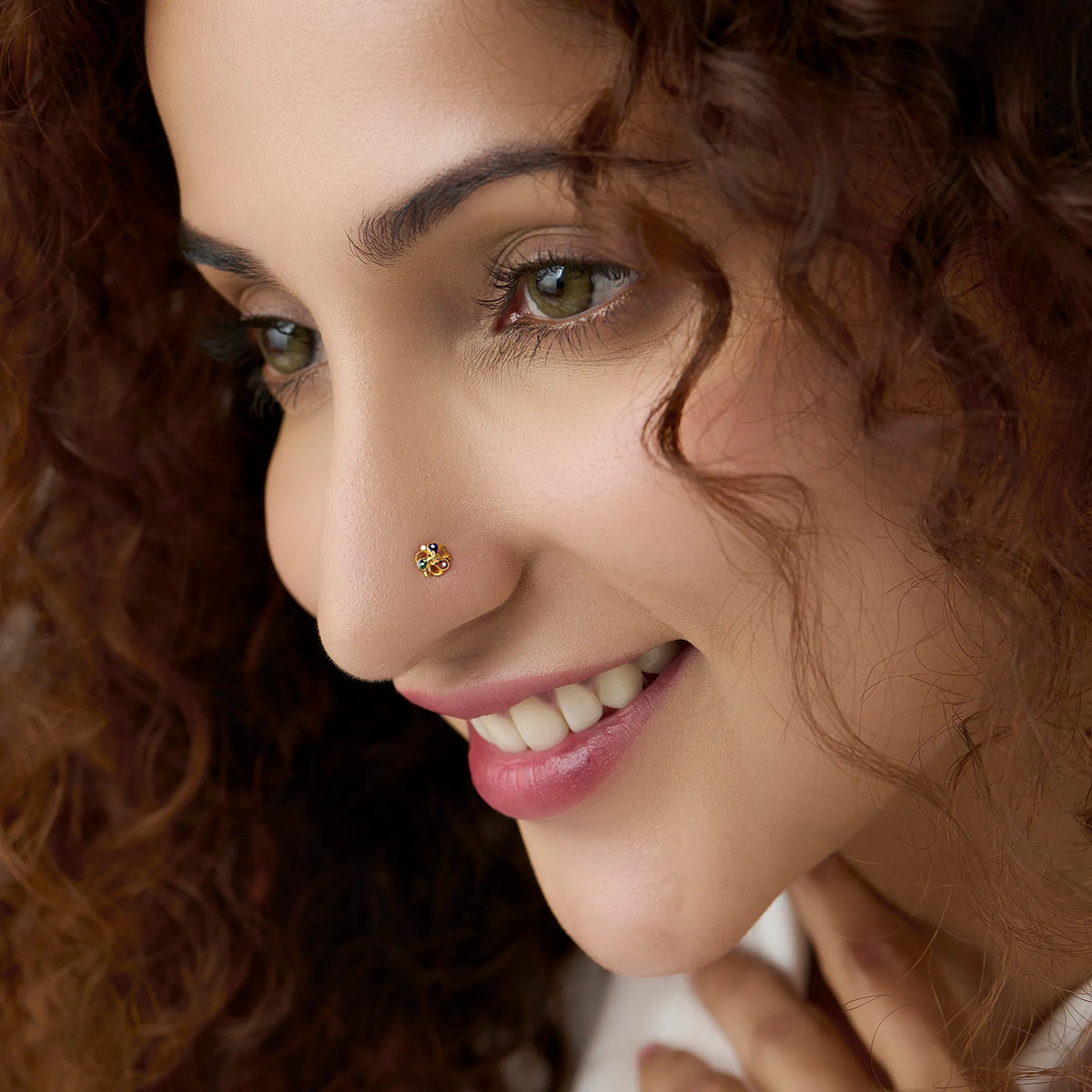 Woman wearing a delicate 18K gold floral nose pin showcasing its elegant and minimal everyday look