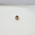 Small 18K gold floral nose pin captured on a white background showing its polished finish