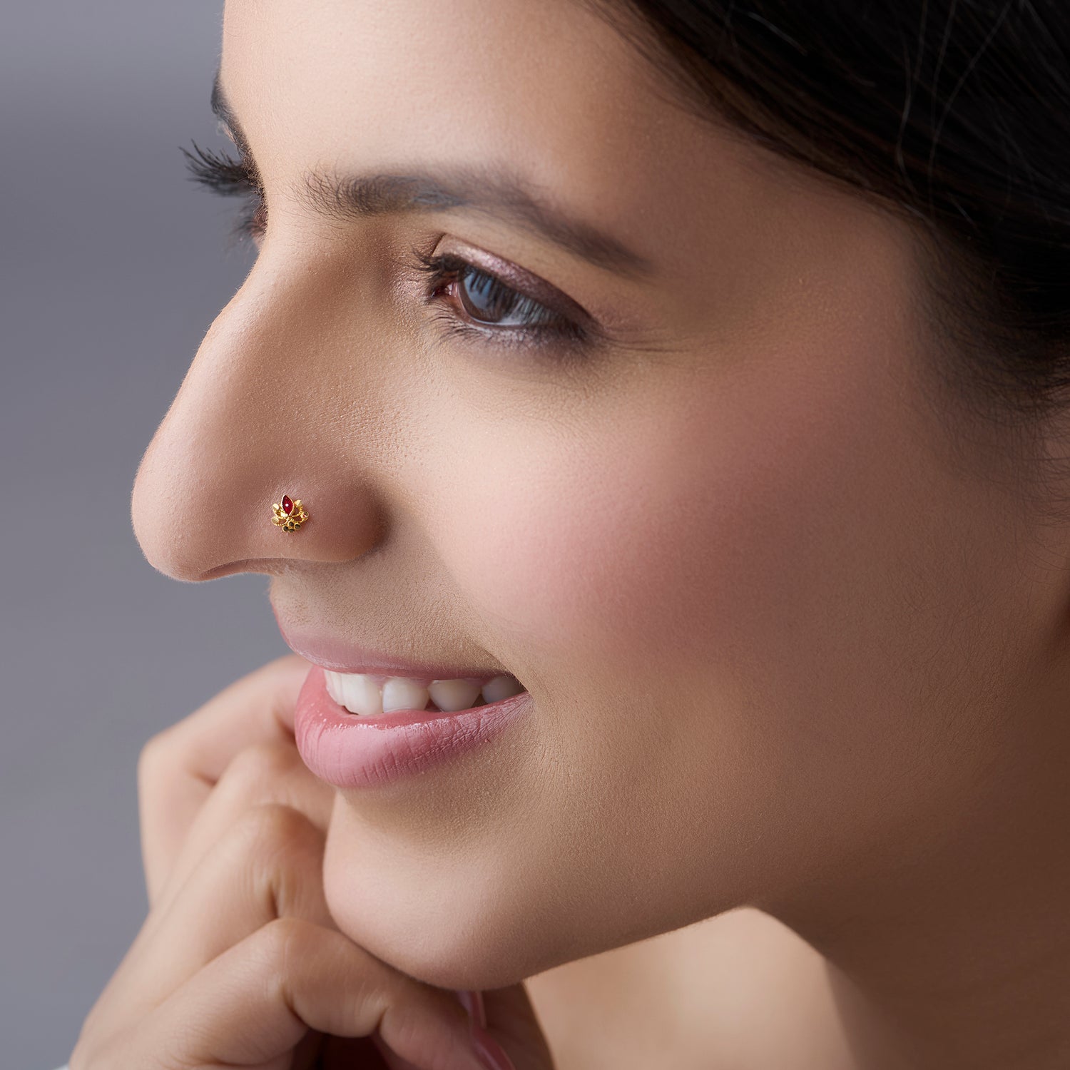 Woman wearing a delicate floral 18K gold nose pin showcasing an elegant everyday look