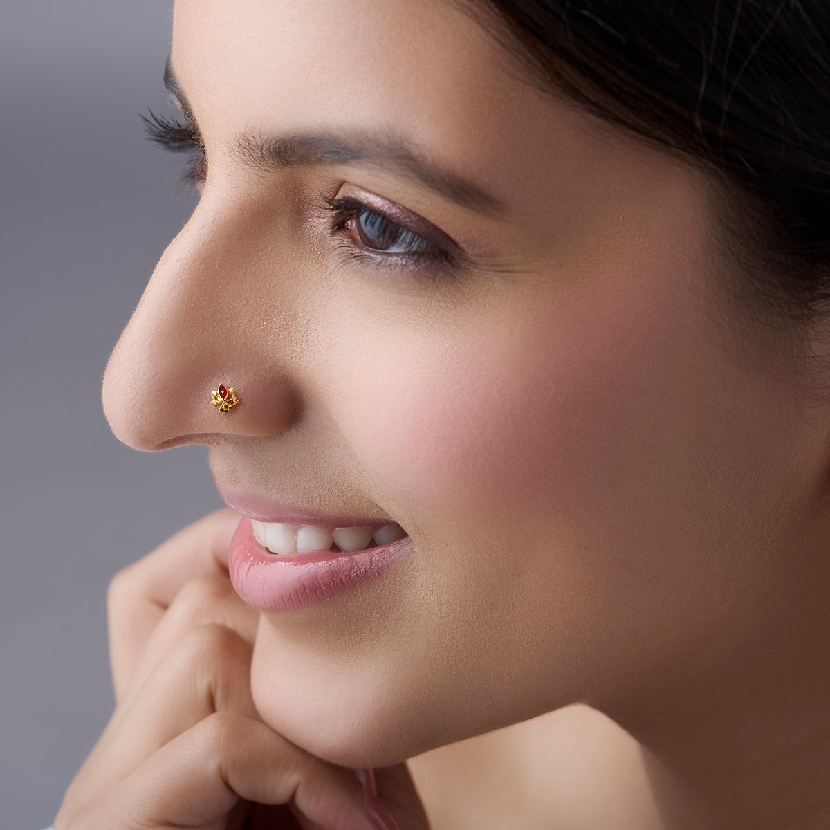 Woman wearing a delicate floral 18K gold nose pin showcasing an elegant everyday look
