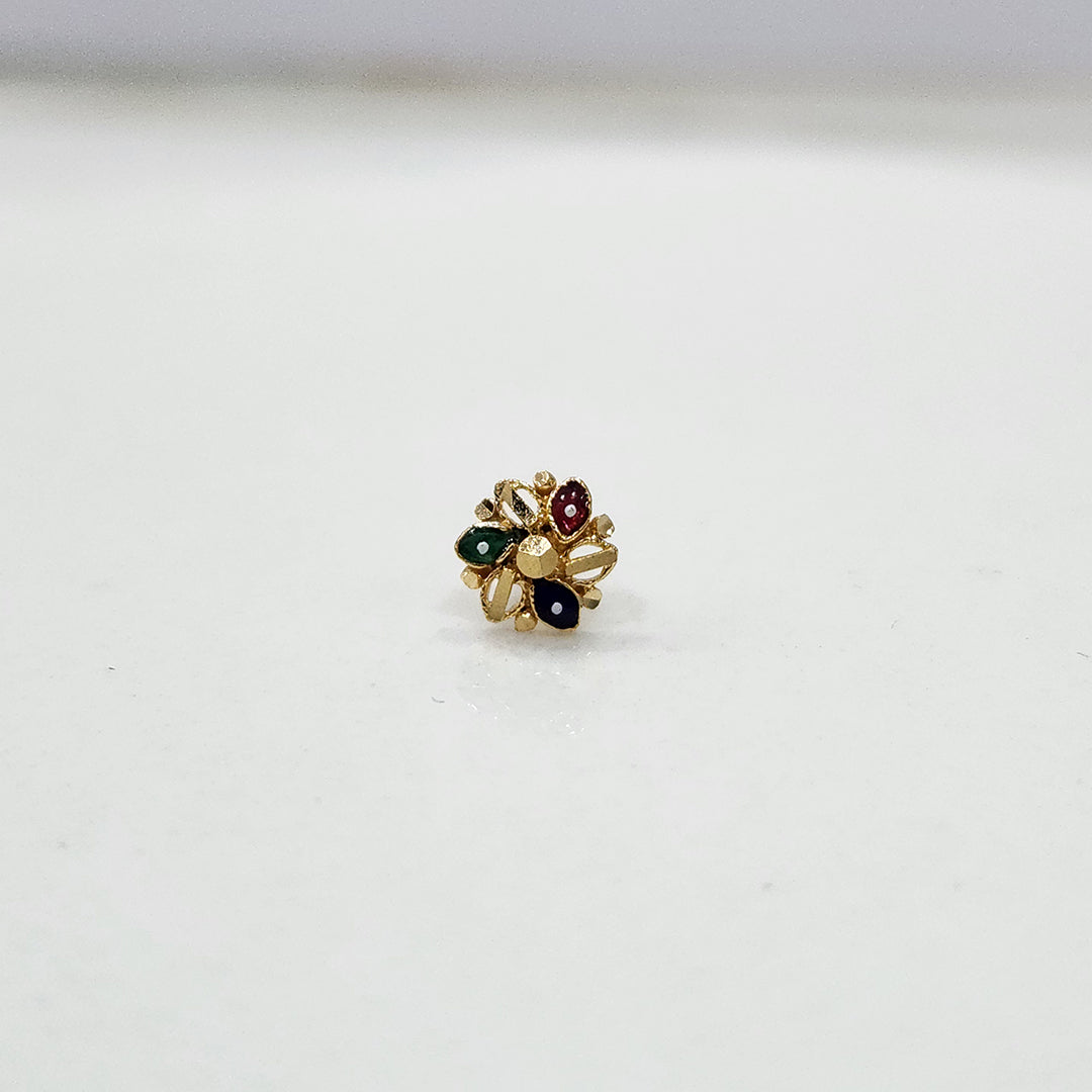 Close-up of multicolour floral 18K nose pin gold on a clean white background highlighting its fine craftsmanship