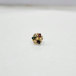 Close-up of multicolour floral 18K nose pin gold on a clean white background highlighting its fine craftsmanship