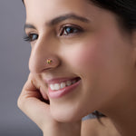 Woman wearing multicolour floral 18K nose pin gold showcasing a bright and elegant everyday look