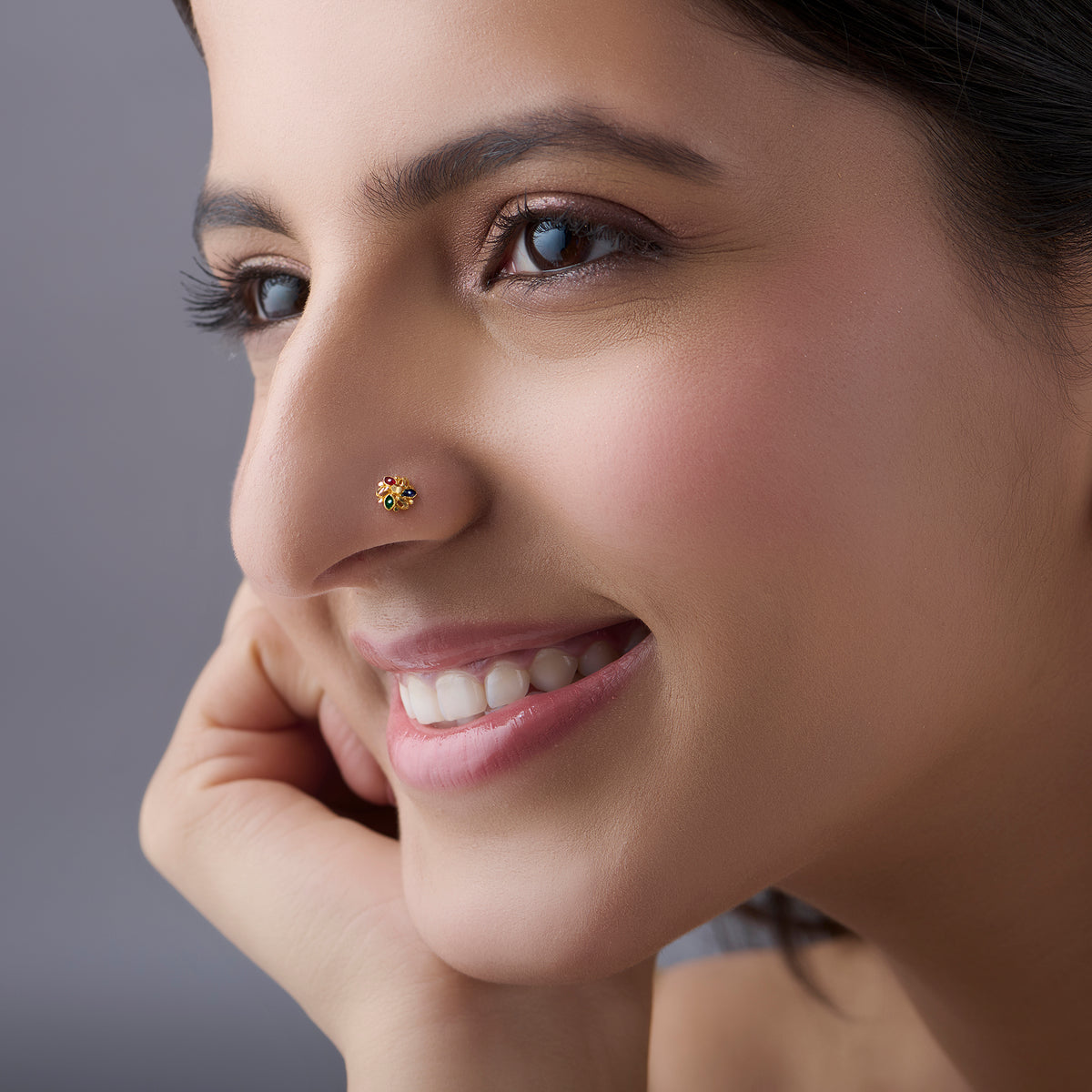 Woman wearing multicolour floral 18K nose pin gold showcasing a bright and elegant everyday look