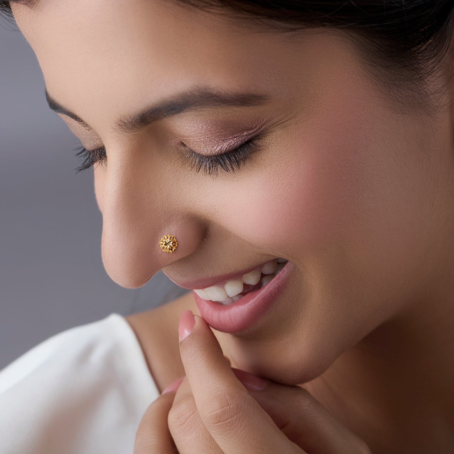 Woman wearing a floral 18K nose pin gold showcasing a soft elegant ethnic look