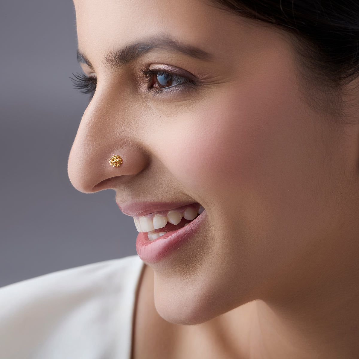 Woman wearing a floral 18K nose pin gold showcasing a soft elegant everyday ethnic look