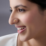 Woman wearing a floral 18K nose pin gold showcasing a soft elegant everyday ethnic look