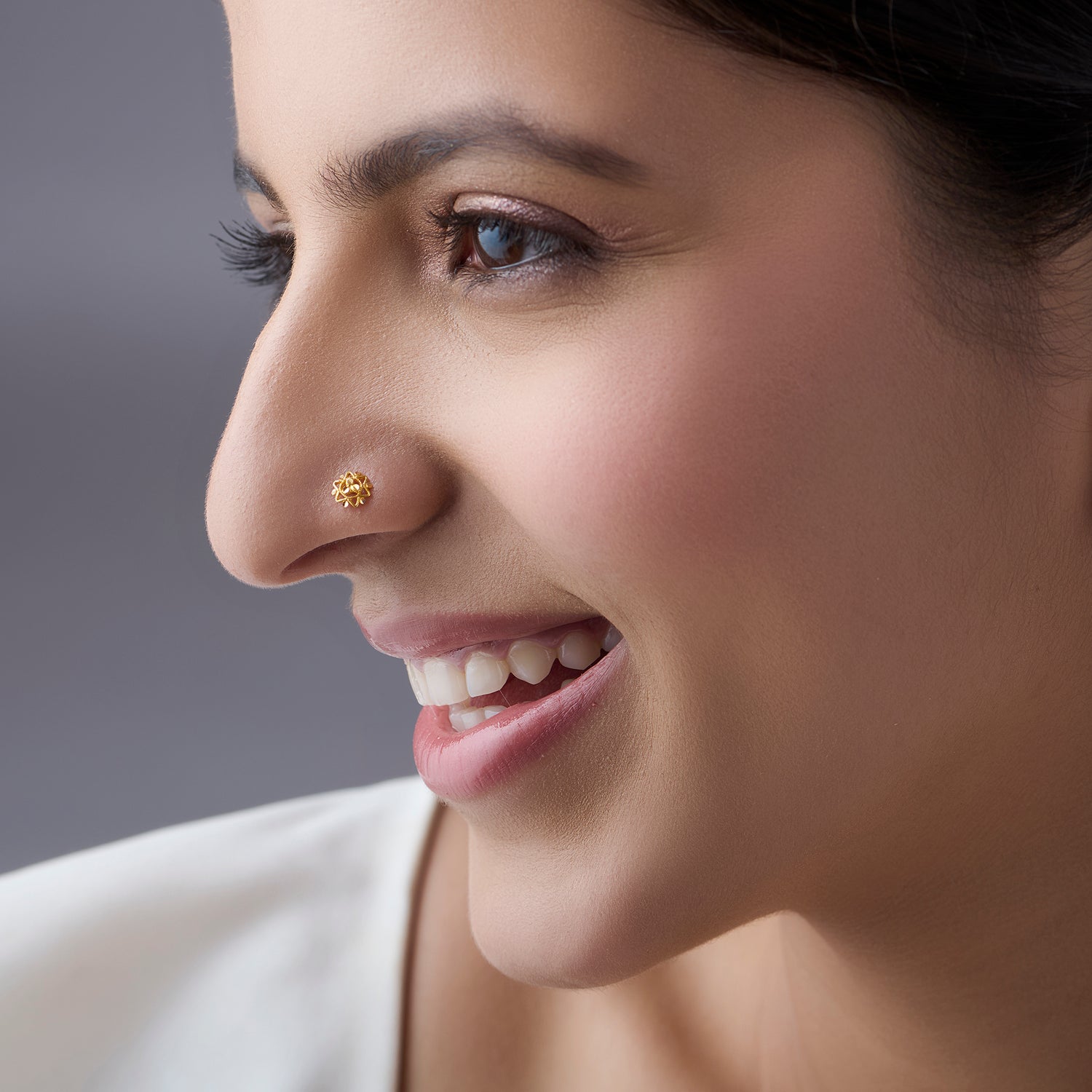 Woman wearing a floral 18K nose pin gold showcasing a soft elegant everyday ethnic look
