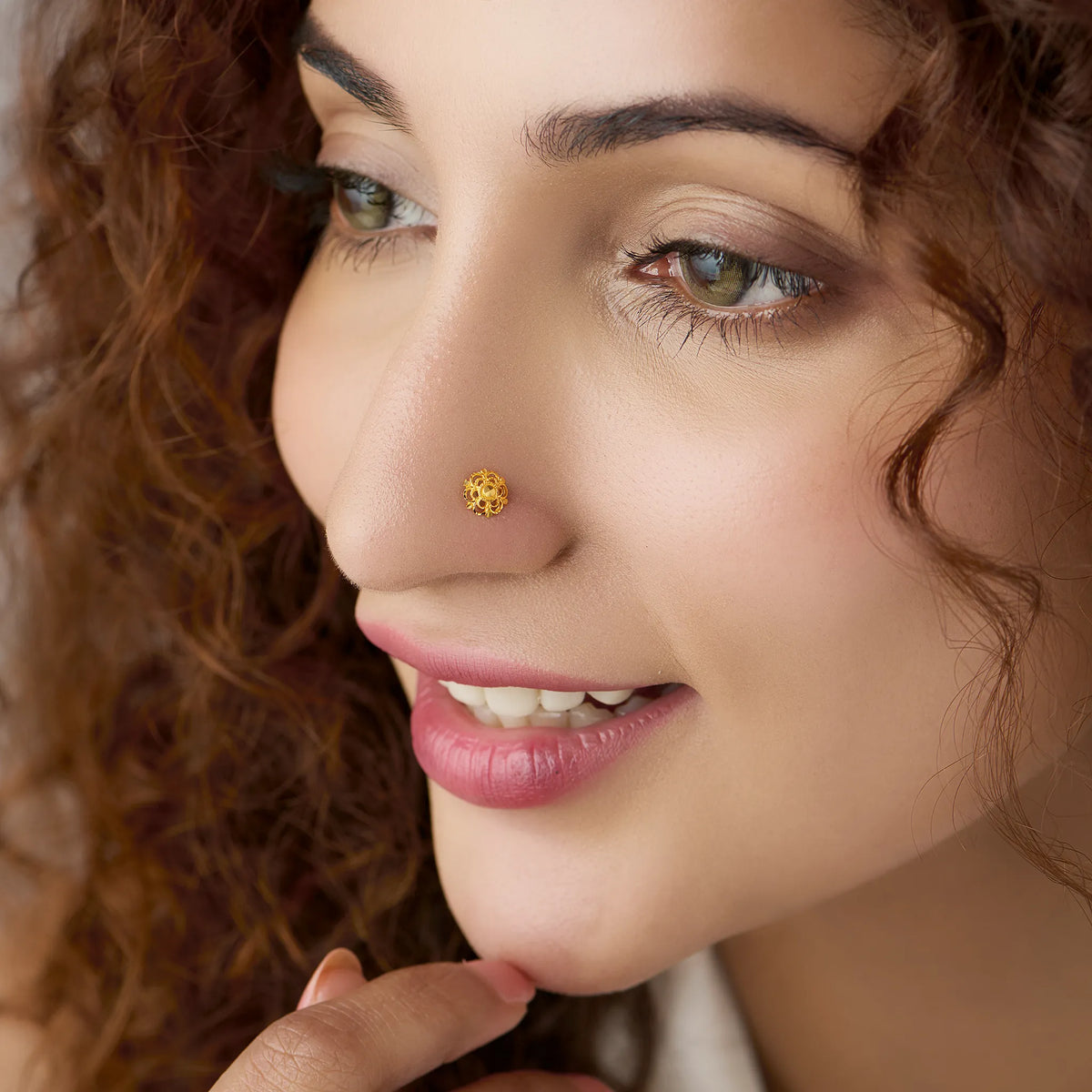 Woman wearing floral 18K nose pin gold showcasing a delicate and elegant everyday look