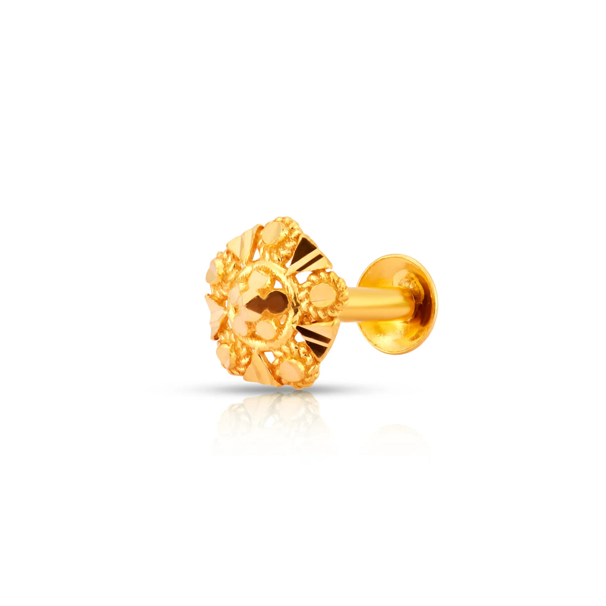 Close-up shot of an intricately carved 18K nose pin gold showcasing its detailed floral craftsmanship