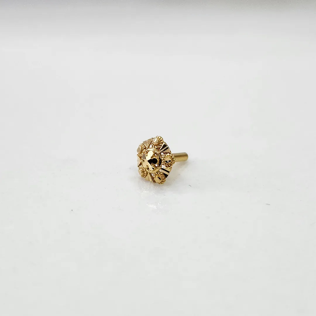 Tiny 18K nose pin gold placed on a white surface highlighting its delicate structure