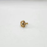 Tiny 18K nose pin gold placed on a white surface highlighting its delicate structure