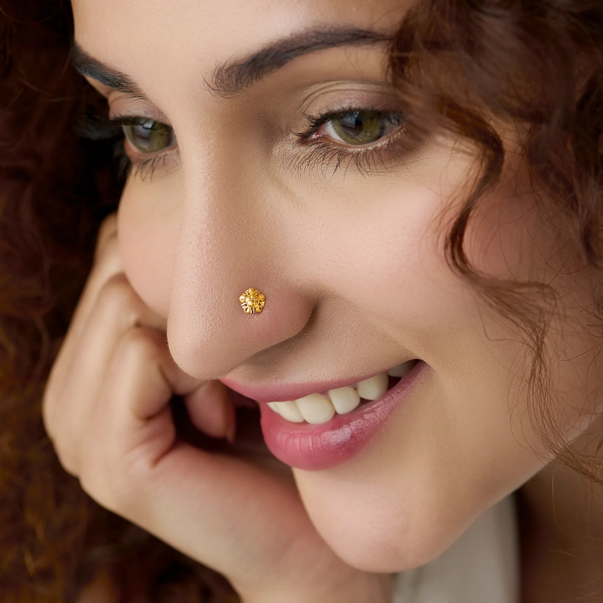 Woman wearing a tiny 18K nose pin gold showing an elegant and minimal ethnic look