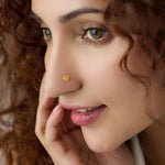 Woman wearing delicate sun-motif 18K nose pin gold showcasing an elegant everyday look