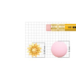 Sun-design 18K nose pin gold placed on a measurement grid showing precise height and width