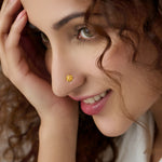 Woman wearing a small floral gold nose pin showing a graceful and elegant everyday style